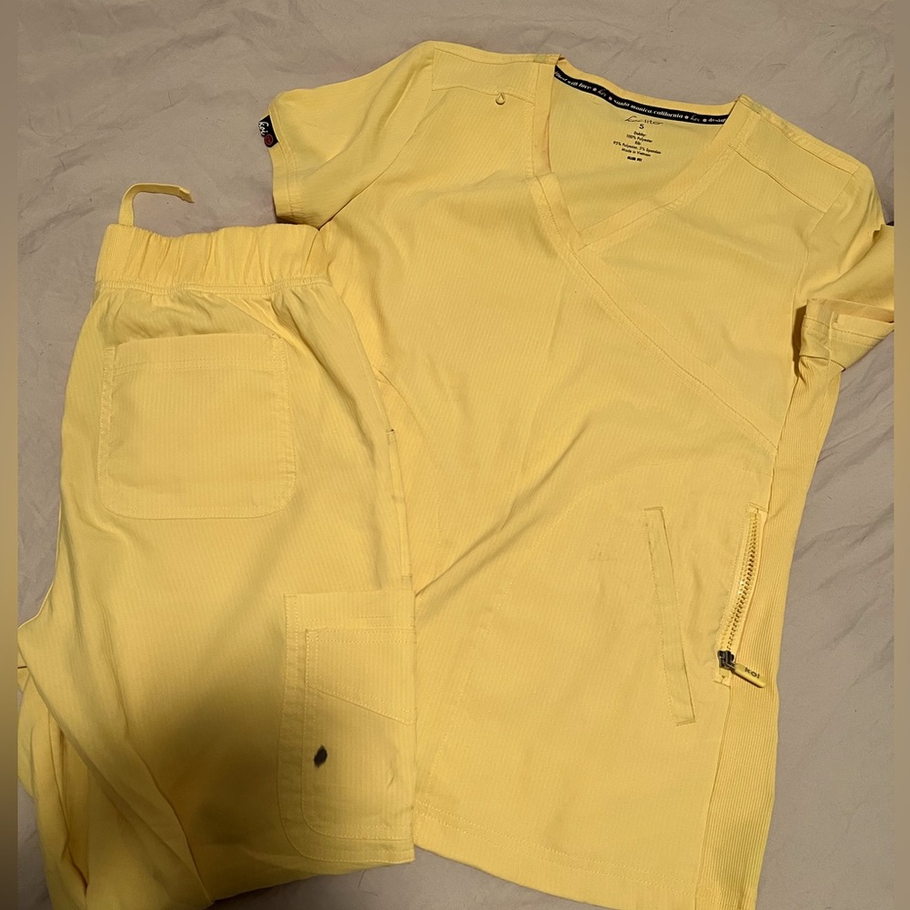 Koi Lite ( Yellow ) scrubs, worn twice. As seen in picture pocket has a pen mark